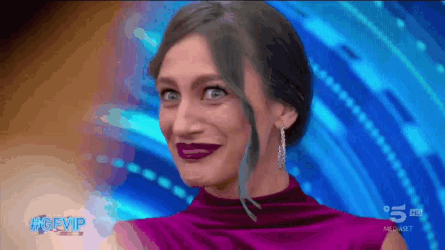 a woman wearing a purple dress and earrings is on a tv show called gfvip