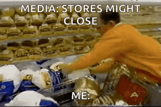 a man is pushing a shopping cart full of groceries in a store .