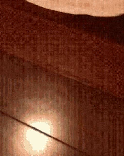 a close up of a wooden floor with a light shining on it
