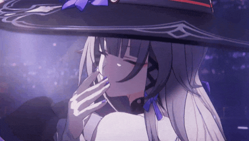 a close up of a girl wearing a witch hat with a purple bow