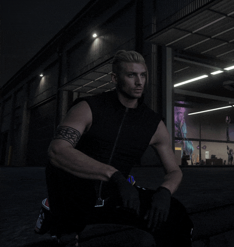 a man with a tattoo on his arm sits in front of a building at night