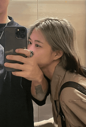 a woman taking a picture of herself in a mirror with a ring on her finger that says 210f