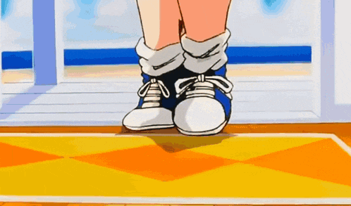 a person wearing a pair of blue and white sneakers is standing on a yellow mat .