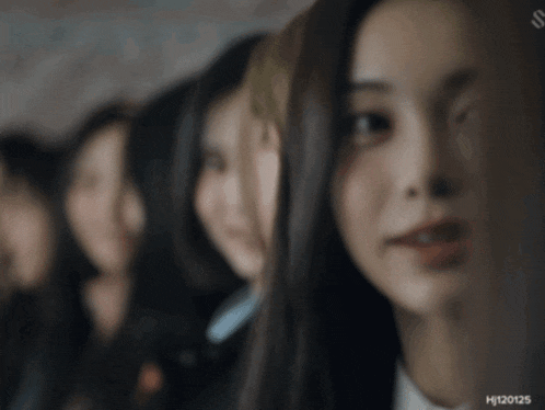 a blurred image of a group of women with the numbers hj120125 on the bottom