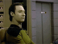 a man in a yellow shirt is sitting in a chair in front of a door