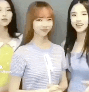 a group of three women are standing next to each other and smiling .