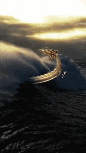 a dragon is flying through the air over the ocean