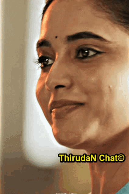 a close up of a woman 's face with the words thiruda n chat on the bottom right