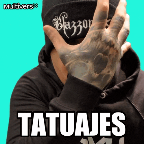 a man with a tattoo on his hand is wearing a beanie that says blazers