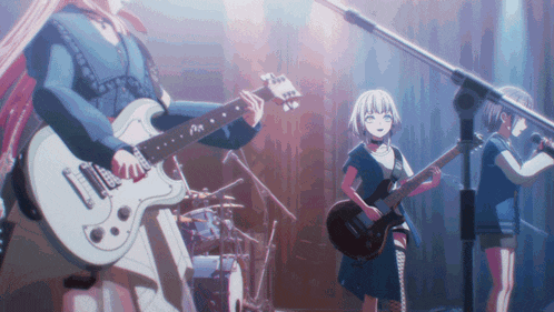 a group of girls are playing guitars and singing into microphones on a stage