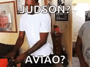 a man in a white shirt is standing in a room with the words judson aviao written on it