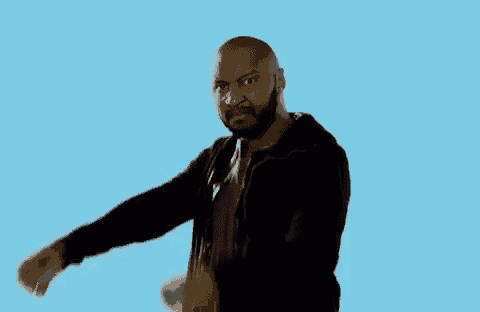 a man with a beard is standing in front of a blue background .