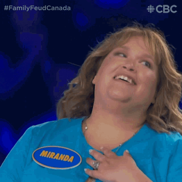 a woman is wearing a blue shirt with a name tag that says miranda