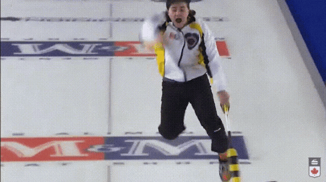 a person is jumping in the air in front of a sign that says mgm on it