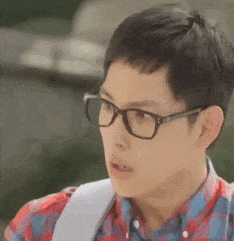 a man wearing glasses and a plaid shirt