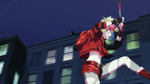 harley quinn is holding a bat in her hand in front of a building at night