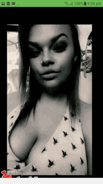 a black and white photo of a woman on a cell phone screen