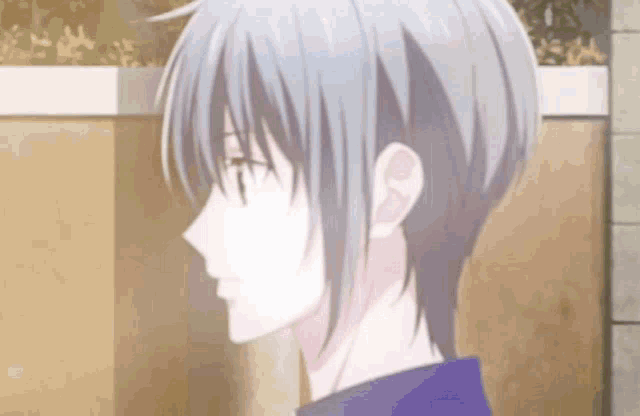 a close up of a person 's face with a short haircut .
