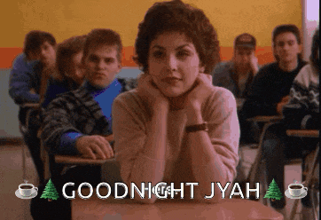 a woman sits at a desk in a classroom with the words goodnight jyah
