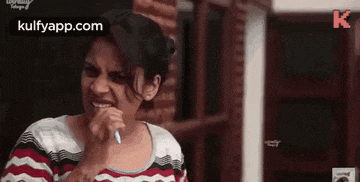 a woman is brushing her teeth with a toothbrush .