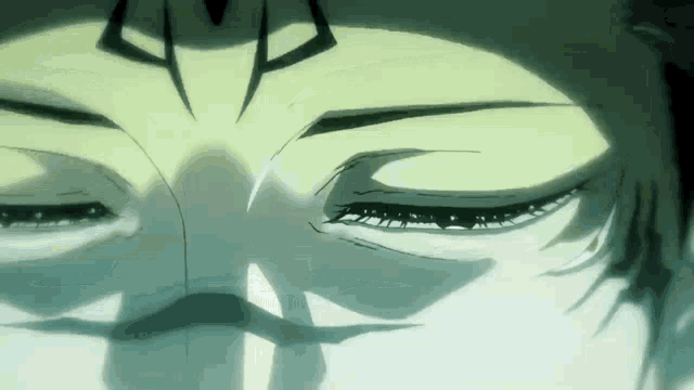 a close up of a person 's face with their eyes closed and a shadow on their face .