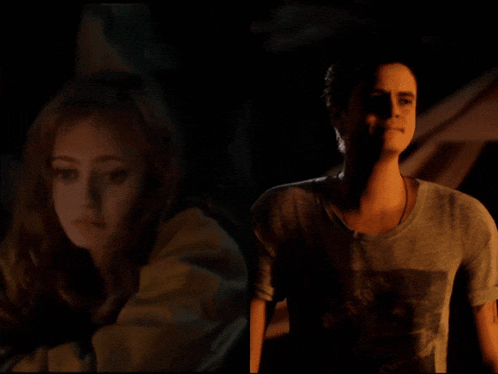 a man and a woman standing next to each other in the dark