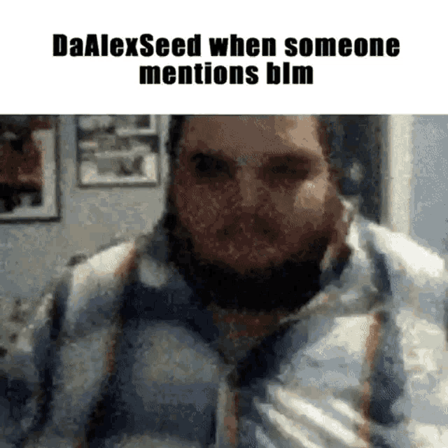 a man with a beard is talking on a video call while someone mentions blm .