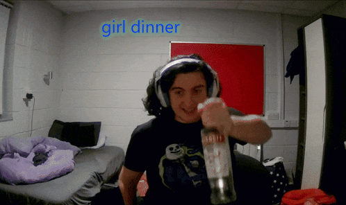 a man wearing headphones is holding a bottle in front of a sign that says " girl dinner "