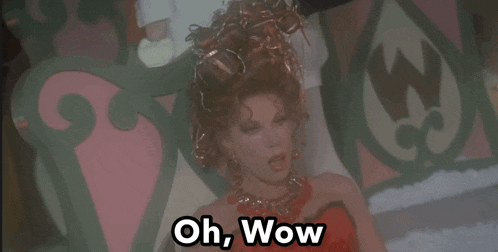 a woman in a red dress is laying down and says oh wow