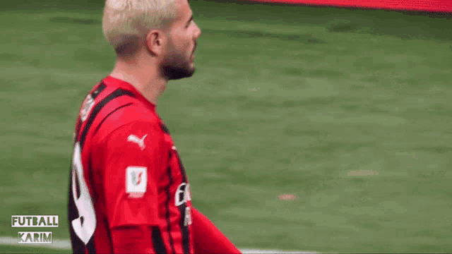 a soccer player wearing a red jersey with the number 9 on the back