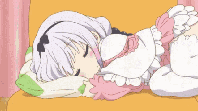 a girl is sleeping on a couch with her eyes closed .