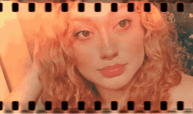 a close up of a woman 's face with film strips around it