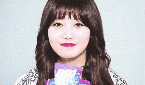 a close up of a girl 's face with a purple scarf around her neck