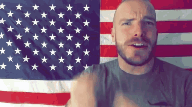 a man stands in front of an american flag with stars on it