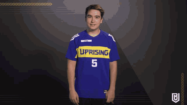 a man wearing a blue and yellow uprising jersey