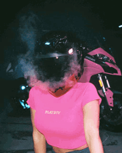 a woman wearing a pink shirt that says playboy