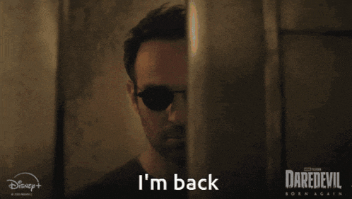 a man wearing sunglasses says i 'm back behind a wall