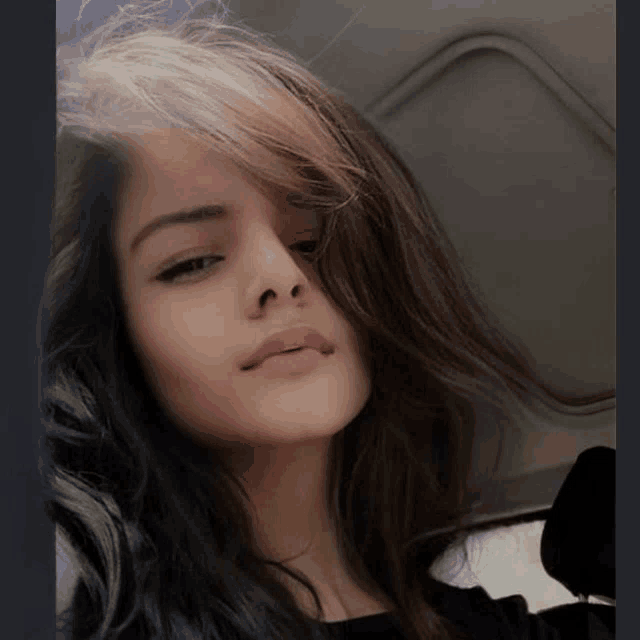 a close up of a woman 's face with dark hair