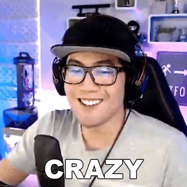 a man wearing glasses and headphones is smiling and the word crazy is on the bottom