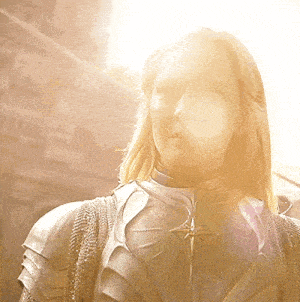 a woman wearing a knight 's armor with a star on her chest