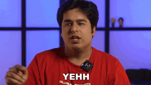a man wearing a red shirt that says yehh on it