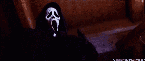 ghostface from the movie scream is wearing a black hooded jacket and screaming .