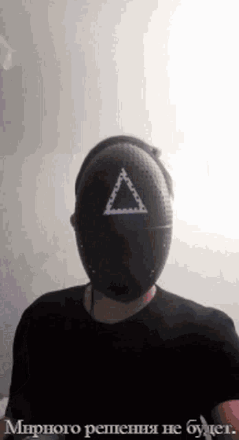 a man is wearing a mask with a triangle on it