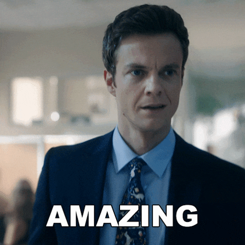 a man in a suit and tie is standing next to the word amazing