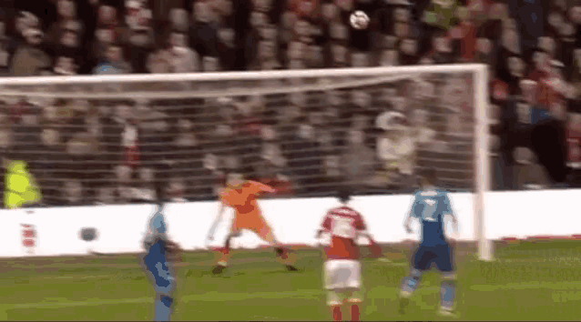 a blurry picture of a soccer game with the number 7 on the back of a player 's jersey