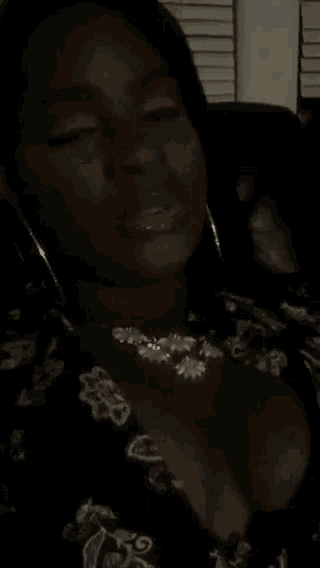 a woman with her tongue out wearing a necklace