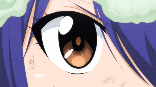 a close up of a girl 's eye with a blue hair