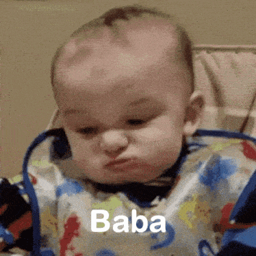 a baby wearing a bib is making a funny face and the word baba is visible