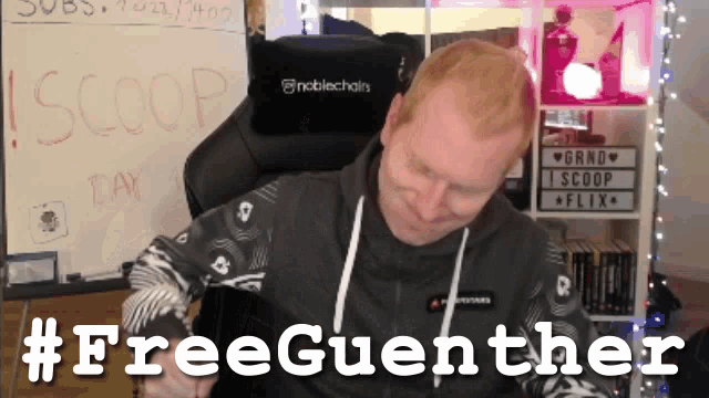 a man sitting in a chair with the hashtag #freeguenther on the bottom