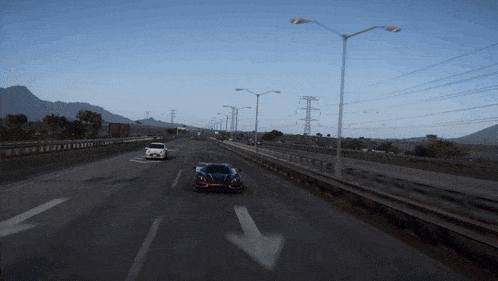 a car driving down a highway with an arrow pointing to the right